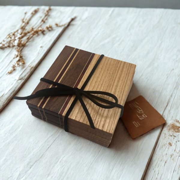 Fa poháralátét szett nemesfák találkozásával. Fekete diófa, kőrisfa, padauk és juharfa kombinációja. Vízlepergető kezeléssel. 100% kézműves termék.